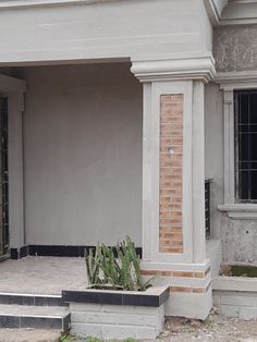 a cat sitting on the steps in front of a house