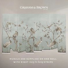 an advertisement for graham & brown featuring cranes and flowers on teal blue background with text