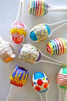 there are many lollipops on the stick with different colors and designs in them