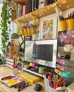 a desk with a computer monitor, keyboard and various office supplies on it's shelves