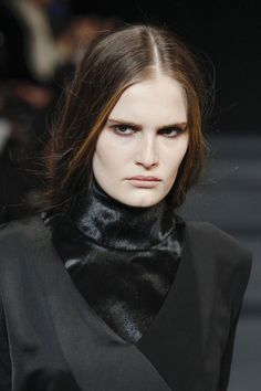 a model walks down the runway wearing black