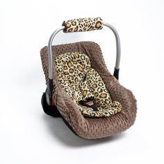 a baby car seat with a leopard print cover on it's back and side