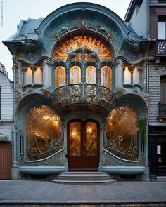 an elaborately designed building on the corner of a street