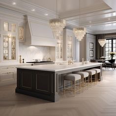 a large kitchen with marble counter tops and white cabinets, along with bar stools