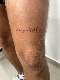 a man with a tattoo on his leg that says i love math and is written in black ink