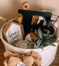 a white bucket filled with assorted items on top of a wooden table