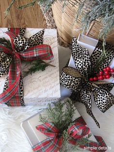 two wrapped presents sitting on top of a white fur covered floor