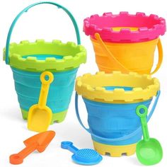 three plastic buckets with shovels and spoons on the side, one in different colors