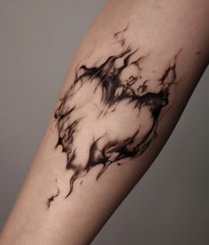 a woman's arm with black ink on it