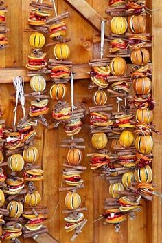 a wooden wall covered in lots of different types of food hanging from it's sides