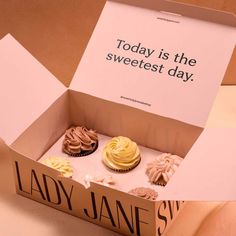 a box that has some cupcakes in it with a sign on the inside