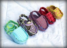 four purses are lined up on a white sheet