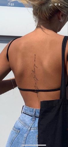 the back of a woman's body with writing on her left shoulder and right arm