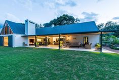 a large white house sitting on top of a lush green field