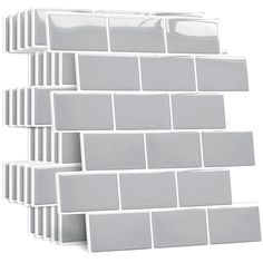 a stack of white tiles sitting on top of each other in front of a white background