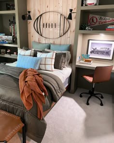 a bedroom with a bed, desk and shelves on the wall above it that has bookshelves