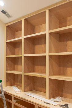 an unfinished bookcase is being built with plywood