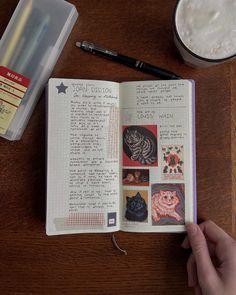 an open book with pictures and writing on it next to a cup of coffee, pen and pencil