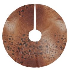 a close up of a wooden disk with spots on it's surface and a white background