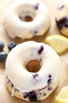 blueberry lemon donuts with white icing and fresh blueberries on the side