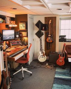 a room with guitars and other musical equipment