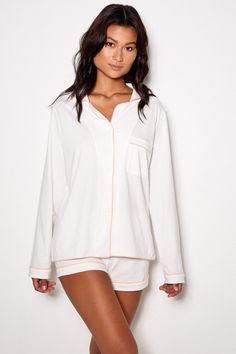 Discover the perfect women's pajama set for ultimate comfort and style. Our Ivory Pajama Set is the ideal nightwear for those long days and cozy mornings. Cut & Fit Button-down long-sleeve jacket Relaxed fit short, elasticated waist Pink Contrast piping Lining & Fabric Soft Jersey Cotton 32s Machine wash Model Measurements: Height 176 cm | Bust 85 l Waist 65 | Hips 93 The model wears a small Wrap yourself in our Ivory Pajama Set and enjoy a night of relaxation and indulgence. Whether you White Long Sleeve Sleepwear For Pajama Party, White Long Sleeve Sleepwear For Lounging, White Long Sleeve Relaxed Fit Sleepwear, Cozy White Sleepwear For Loungewear, Cozy Long Sleeve Cream Sleepwear, Cream Long Sleeve Loungewear Sleepwear, Cream Long Sleeve Sleepwear For Lounging, White Relaxed Fit Sleepwear For Daywear, Long Sleeve Cream Sleepwear For Lounging