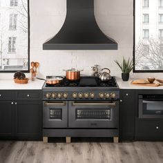 a stove top oven sitting inside of a kitchen next to an oven and countertop