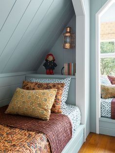 there is a bed in the room with two pillows on it and a teddy bear