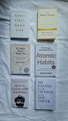 four books are laid out on a white sheet