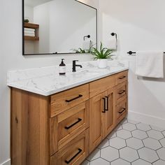 a bathroom with two sinks and a large mirror