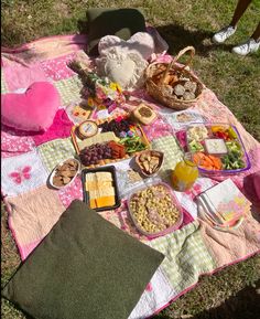 a picnic blanket with food and drinks on it