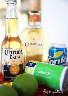 bottles of alcohol, limes and spices on a table