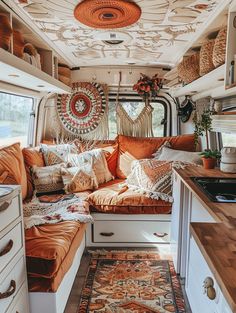 the inside of a camper with lots of pillows