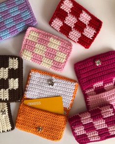 four crocheted purses sitting next to each other