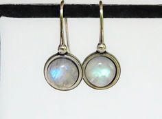 ~  Natural Rainbow Moonstone ~  Lots of blue flash ~  Gemstone Size: 8mm  ~  Earring Size: M to L ~  Recycled Sterling Silver ~  Beautiful every day earrings ~  Sparkly, handmade and nickel free ~  June Birthstone Some History and Folklore, courtesy of the Gemological Institute of America:  According to Hindu mythology, Moonstone is made of solidified moonbeams. Many other cultures also associate this gem with moonlight, and it's easy to see why. Its internal structure scatters the light that strikes it, creating a visual effect reminiscent of the full moon shining through a veil of thin, high clouds. Legends say that Moonstone brings good luck to the wearer. Our jewelry is shipped in jewelry gift boxes perfect for gifting. ❤ Gift wrap is available in the cart. You can find all of our Art Moonstone Earrings With Moon Charm, Adjustable Moon-shaped Moonstone Earrings, Round Moonstone Earrings, Everyday Round Moonstone Earrings, Nickel-free Moonstone Round Earrings, White Round Moon Phase Earrings, Handmade Round Moonstone Earrings, High Clouds, Deco Earrings