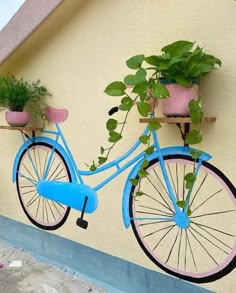 a blue bicycle with potted plants attached to it