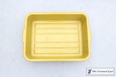 a yellow plastic container sitting on top of a white table