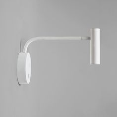 a white wall light on a gray wall with a long arm and two lights attached to it