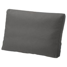 a gray pillow is laying on a white surface