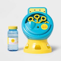 a blue and yellow toy with toothbrushes in it next to a water bottle