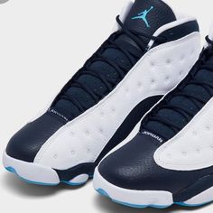 The Air Jordan 13 Retro ‘Obsidian’ Updates The Vintage Mid-Top With A Familiar Color Scheme, One That Combines Stitched Tumbled White Leather With Contrasting Navy Blue Paneling. A Jumpman Icon In Dark Powder Blue Is Embroidered Atop The Tongue, While The 13’s Holographic Cat Eye Decorates The Lateral Ankle. Underfoot, The Distinctive Panther Paw Outsole Features Herringbone Rubber Traction Pods And A Carbon Fiber Shank Plate For Improved Stability. Navy Leather Sneakers With Boost Midsole, Navy Leather High-top Basketball Shoes, Navy Leather Basketball Shoes With Round Toe, Navy Leather Basketball Shoes With Cushioned Footbed, Navy Basketball Shoes With Boost Midsole, Blue Paneling, Jordan Retro 2, Jordan Retro 10, Air Jordan Retro 4