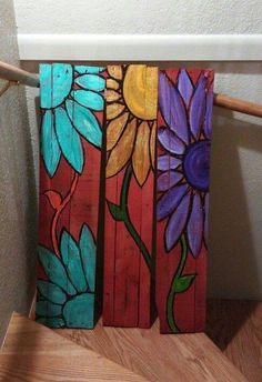 an image of some colorful flowers painted on wooden planks in the shape of sunflowers