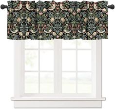 a window with a black and green floral curtain valance