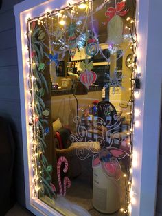 a window with christmas decorations and lights in it