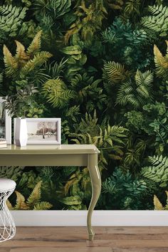 a green wallpaper with leaves on it and a white table in front of it