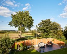 a backyard with a wooden fence and green grass