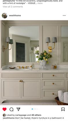 the bathroom is decorated in white with gold accents and flowers on the sink countertop