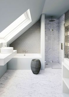 a white bathroom with a skylight above the bathtub