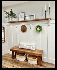 a bench with two baskets under it and a hat on the top shelf above it