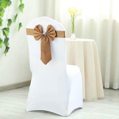 a white chair with a brown bow on it